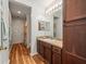 Bathroom with a wood-look floor, wooden cabinets, a built-in cabinet and a shower/bath with curtains at 15720 Ibisridge Dr, Lithia, FL 33547