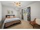 Cozy bedroom with neutral tones, carpet, and a decorative window with patterned drapes at 15720 Ibisridge Dr, Lithia, FL 33547