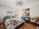 Bright bedroom with hardwood floors, a Kobe Bryant poster, and a ceiling fan with unique circular design at 15720 Ibisridge Dr, Lithia, FL 33547