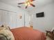 Cozy bedroom with a ceiling fan, a double door closet, and a wall-mounted television for entertainment at 15720 Ibisridge Dr, Lithia, FL 33547