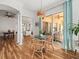 Bright dining area features a modern light fixture, wood floors, and sliding glass doors to the patio at 15720 Ibisridge Dr, Lithia, FL 33547