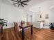 Open-concept area with wood floors and an elegant dining table at 15720 Ibisridge Dr, Lithia, FL 33547