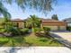 Charming single-story home featuring a three-car garage and lush landscaping at 15720 Ibisridge Dr, Lithia, FL 33547