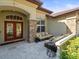 Beautiful front door leading to the outdoor seating area at 15720 Ibisridge Dr, Lithia, FL 33547