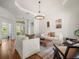 Cozy living room with natural light, wood floors, and a modern chandelier at 15720 Ibisridge Dr, Lithia, FL 33547