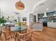 Open-concept living area with a modern kitchen, fireplace, and hardwood floors at 15720 Ibisridge Dr, Lithia, FL 33547