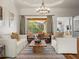Bright living room features stylish furnishings and access to the outdoor patio at 15720 Ibisridge Dr, Lithia, FL 33547