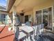 Covered outdoor patio area with dining table, exterior fan, and plush seating at 15720 Ibisridge Dr, Lithia, FL 33547