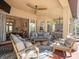 Spacious covered outdoor patio with plush seating, a ceiling fan, and a TV at 15720 Ibisridge Dr, Lithia, FL 33547