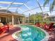 Inviting screened-in pool area with comfortable seating and a relaxing outdoor ambiance at 15720 Ibisridge Dr, Lithia, FL 33547