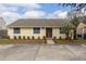 Inviting yellow home featuring a well-maintained front yard and a charming walkway to the front door at 16135 Sandcrest Way, Tampa, FL 33618