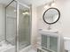 Bathroom featuring a glass shower and a modern vanity with an oval mirror at 2003 Mcmullen Ave, Dunedin, FL 34698