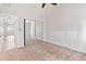 Bedroom featuring neutral walls, wainscotting, carpet flooring, and mirrored closet doors at 2003 Mcmullen Ave, Dunedin, FL 34698