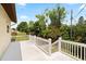 White wooden deck overlooking lush greenery, offering a serene outdoor space at 2003 Mcmullen Ave, Dunedin, FL 34698