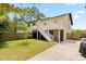 Backyard view of the home featuring a screened in porch and grassy yard at 2003 Mcmullen Ave, Dunedin, FL 34698