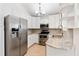 Modern kitchen featuring stainless steel appliances, light countertops, and ample cabinet space for storage at 2003 Mcmullen Ave, Dunedin, FL 34698