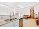 Stylish kitchen with stainless steel appliances, light countertops, and an open view to the living space at 2003 Mcmullen Ave, Dunedin, FL 34698