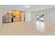 Spacious room with stainless steel refrigerator and door leading to backyard at 2003 Mcmullen Ave, Dunedin, FL 34698