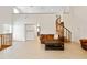 Expansive living room with a spiral staircase, tile floors, and ample space for relaxing and entertaining guests at 2003 Mcmullen Ave, Dunedin, FL 34698