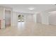 Open-concept living area with tiled floors, neutral walls, and door leading to the backyard at 2003 Mcmullen Ave, Dunedin, FL 34698