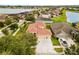 Aerial view of a beige two-story home with a tile roof, three-car garage, and extended driveway at 2604 Dakota Rock Dr, Ruskin, FL 33570