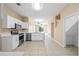 Open-concept kitchen with white cabinets, stainless steel appliances, and tile flooring at 2604 Dakota Rock Dr, Ruskin, FL 33570