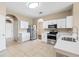 Bright kitchen features stainless steel appliances, tile flooring, and white cabinets at 2604 Dakota Rock Dr, Ruskin, FL 33570