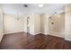 Open-concept living room featuring dark hardwood flooring, archways, and natural light from the window at 2604 Dakota Rock Dr, Ruskin, FL 33570