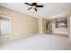 Spacious living room with neutral carpet and views into the kitchen at 2604 Dakota Rock Dr, Ruskin, FL 33570