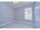 Bedroom with a ceiling fan, closet, and light, neutral-colored walls at 31132 Masena Dr, Wesley Chapel, FL 33545