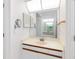 Bathroom with vanity sink and mirror. Reflected in the mirror is a soaking tub and shower at 3414 Shady Brook Ln, Sarasota, FL 34243