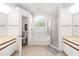 Spacious bathroom featuring double sink vanity, soaking tub, and separate glass enclosed shower at 3414 Shady Brook Ln, Sarasota, FL 34243