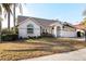 Charming single-story home with a well-manicured lawn, two car garage and a welcoming front entrance at 3414 Shady Brook Ln, Sarasota, FL 34243