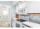 Kitchen features white appliances and cabinetry, stone countertops and adjacent breakfast nook at 3414 Shady Brook Ln, Sarasota, FL 34243