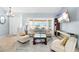 Bright living room featuring neutral tones, modern furnishings, carpet flooring and a vaulted ceiling at 3414 Shady Brook Ln, Sarasota, FL 34243