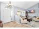 Bright living room featuring neutral tones, modern furnishings, tile flooring and a vaulted ceiling at 3414 Shady Brook Ln, Sarasota, FL 34243