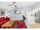 Living room with a comfortable red sofa adjacent to an open kitchen, creating an inviting and sociable space at 3414 Shady Brook Ln, Sarasota, FL 34243