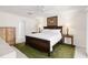 Bedroom featuring a king bed, lamps on nightstands, and access to a connected bathroom at 3414 Shady Brook Ln, Sarasota, FL 34243