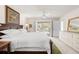 Main bedroom with a king bed and sliding glass door with a view of the pool at 3414 Shady Brook Ln, Sarasota, FL 34243
