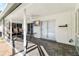 The enclosed patio has brick floors, a ceiling fan, and a tv at 3414 Shady Brook Ln, Sarasota, FL 34243