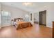 Bright and airy bedroom features wood laminate floors, a comfortable bed, and ample closet space at 36645 Kay Ave, Zephyrhills, FL 33542