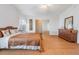 Bedroom with wood laminate floors, shell pillows on the bed, and natural lighting at 36645 Kay Ave, Zephyrhills, FL 33542