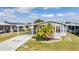 Charming home exterior with carport, landscaping, and a well-maintained lawn at 36645 Kay Ave, Zephyrhills, FL 33542