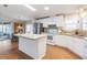 Spacious kitchen with stainless steel appliances, island, and dining area at 36645 Kay Ave, Zephyrhills, FL 33542