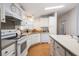 Well-lit kitchen with white appliances, tile backsplash, and white cabinets at 36645 Kay Ave, Zephyrhills, FL 33542