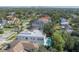 Aerial view of a modern home with a pool, surrounded by lush greenery and neighborhood at 4110 W Swann Ave, Tampa, FL 33609