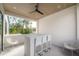 Relax on the balcony with a bar-height table set and ceiling fan for added comfort at 4110 W Swann Ave, Tampa, FL 33609