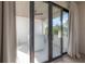 The balcony overlooks trees from a glass door, with white bar-height table and chairs at 4110 W Swann Ave, Tampa, FL 33609