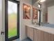 Elegant bathroom features a sleek vanity, a large mirror, and modern decor with an artful accent at 4110 W Swann Ave, Tampa, FL 33609
