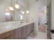 Stylish bathroom with a long vanity and double sinks, pendant lighting, and a view into an adjacent bathroom at 4110 W Swann Ave, Tampa, FL 33609